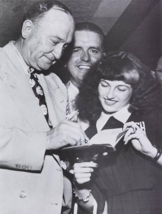 Ty Cobb Signing an Autograph photograph, 1951 July 09