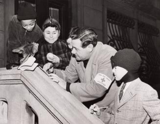 Babe Ruth Signing Autograph as Red Cross Volunteer photograph, 1944 March 04