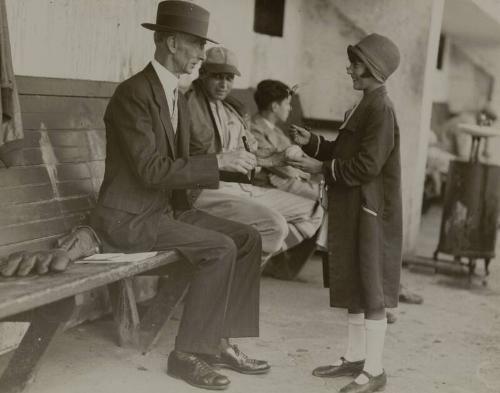 Connie Mack Autographing a Ball photograph, between 1925 and 1935