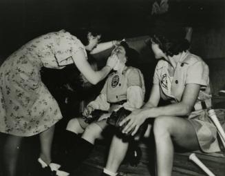 Dottie Hunter Checking Out a Grand Rapids Chicks Player photograph, between 1945 and 1954